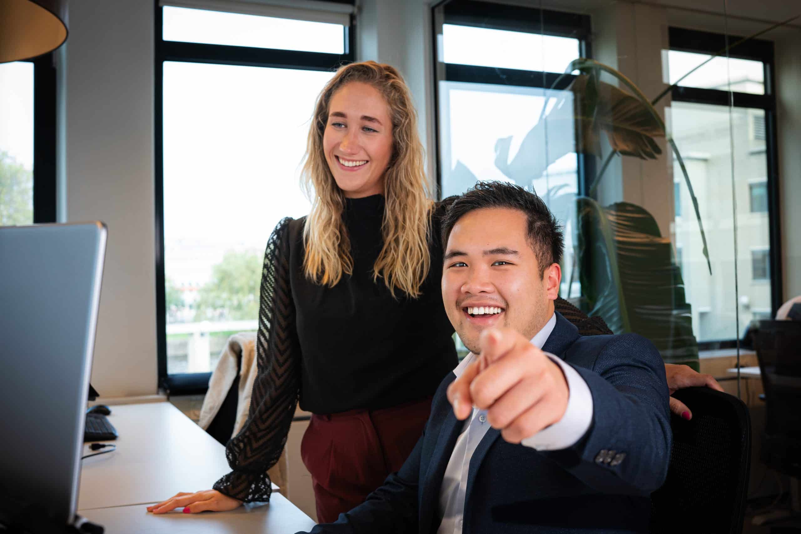 Twee collega's van Finnt lachend achter de computer